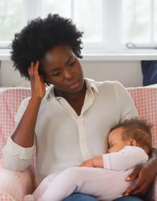 black-mother-holding-baby-looking-stressed-from-perinatal-anxiety