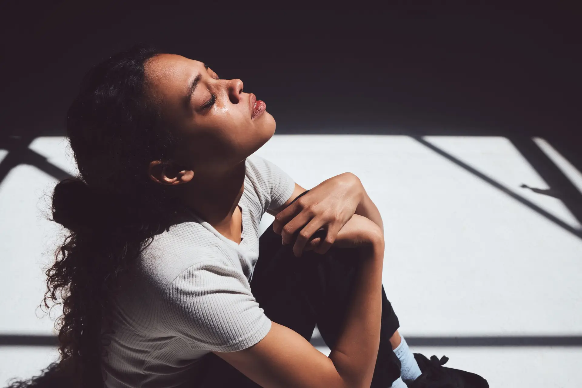 young-woman-with-trauma-sitting-on-ground-crying