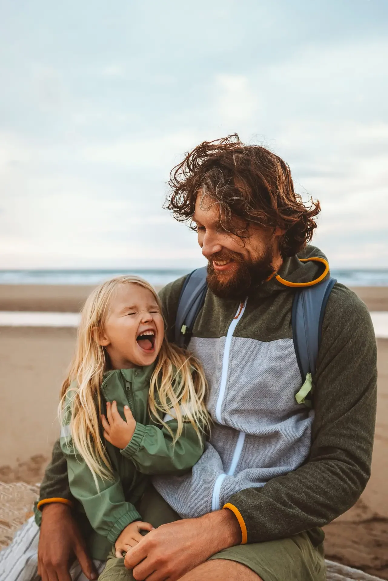 father-and-daughter-at-beach-laughing