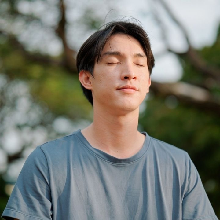Man practicing mindfulness breathing exercise to manage anxiety.
