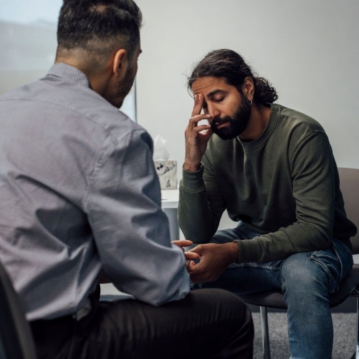 Client speaking with therapist during anxiety recovery session.