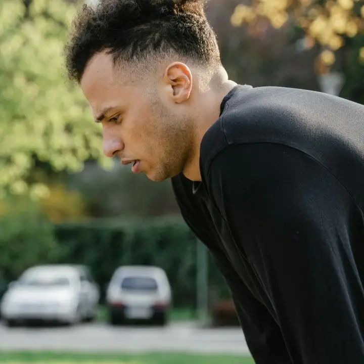 Adult man feeling overwhelmed and stressed outdoors.