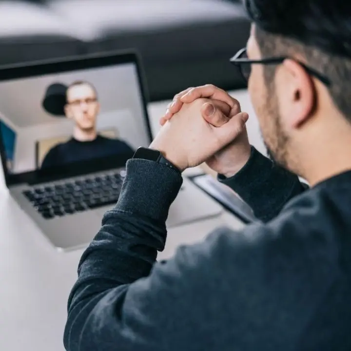 Adult attending virtual therapy session for ADHD support.