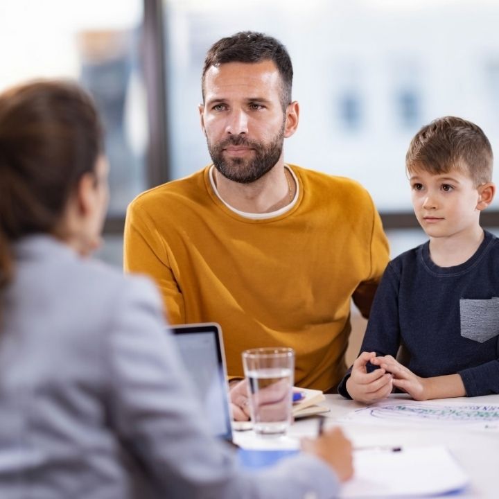 Parent and child discussing OCD symptoms with a mental health professional.