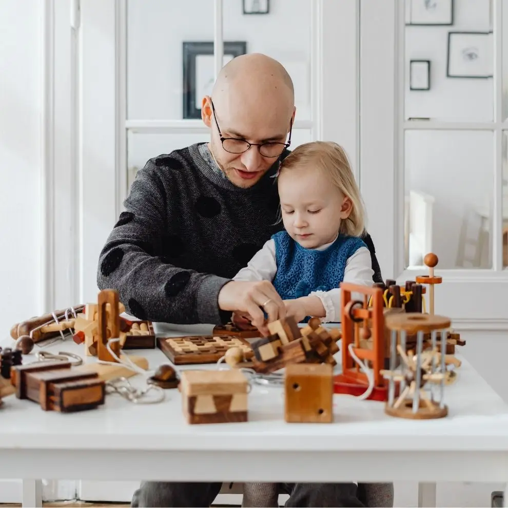 Parent and young child solving wooden puzzles together to support focus and cognitive development.