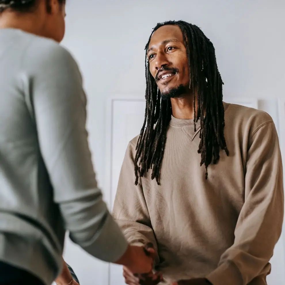 Therapist welcoming a new client with a handshake before starting the first counseling session.