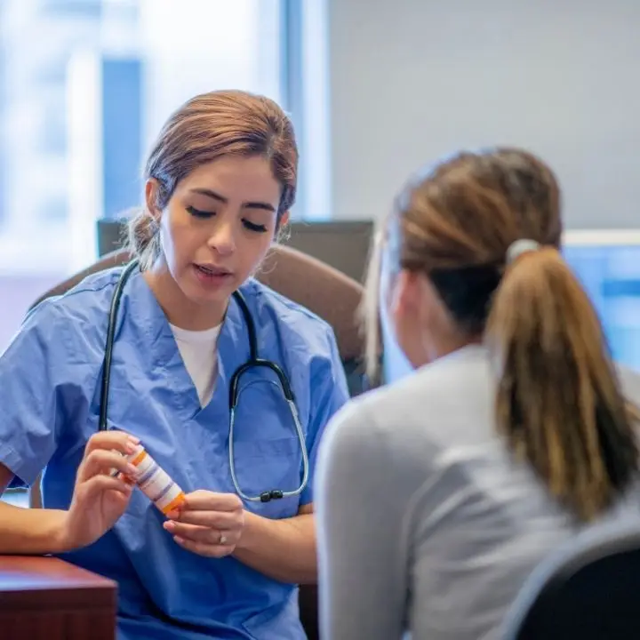 Psychiatric nurse practitioner discussing medication options with a patient during an appointment.